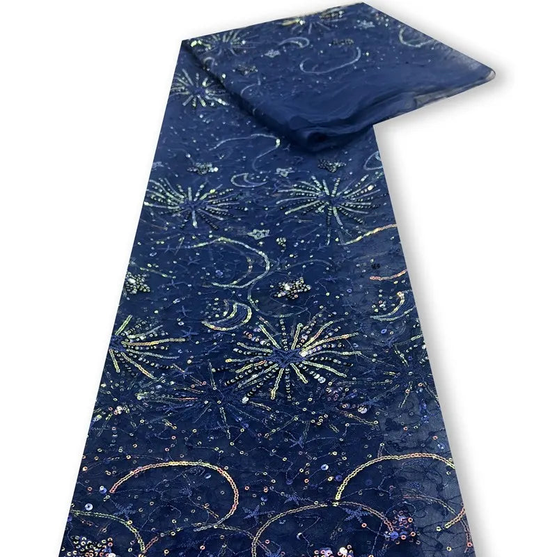 Le Tulle brodé de sequins étoiles et lunes au mètre de Longan Craft France est un tissu bleu foncé avec des motifs d'étoiles et de lunes étincelants, brodés de sequins pour un effet étonnant et élégant - idéal pour les robes.