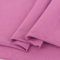 Gros plan sur deux pièces de Tissu French Terry en coton extensible rose de Longan Craft France, à la texture fine et lisse, idéale pour des vêtements de sport confortables.
