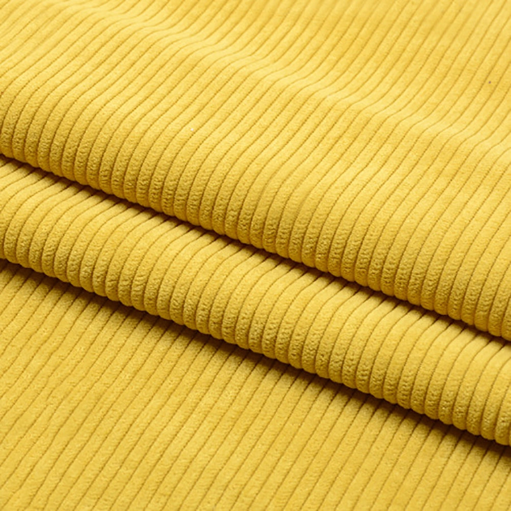 Un gros plan de Tissu velours côtelé épais 8 côtes au mètre de Longan Craft France montre son tissu jaune en polyester à stries verticales, plié en couches. Ce doux matériau est parfait pour l'ameublement et la décoration intérieure.