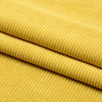 Un gros plan de Tissu velours côtelé épais 8 côtes au mètre de Longan Craft France montre son tissu jaune en polyester à stries verticales, plié en couches. Ce doux matériau est parfait pour l'ameublement et la décoration intérieure.