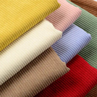 Des pièces vibrantes de Tissu velours côtelé épais 8 côtes au mètre de Longan Craft France en jaune, rose, vert, marron, crème, bleu et rouge sont empilées en diagonale - idéal pour ajouter une texture douillette à votre ameublement.