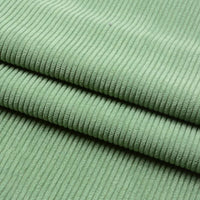 Gros plan sur le Tissu velours côtelé épais 8 côtes au mètre de Longan Craft France, plié en trois couches pour mettre en valeur sa texture douce et ses stries verticales visibles - idéal pour ajouter de la profondeur à votre décoration intérieure.