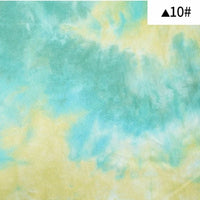 Tissu French Terry en coton tie-dye au mètre de Longan Craft France, imprimé en dégradé bleu clair, vert et jaune. Étiquette blanche avec triangle noir et "10#" en haut à droite. Idéal pour sweatshirts et vêtements confortables.