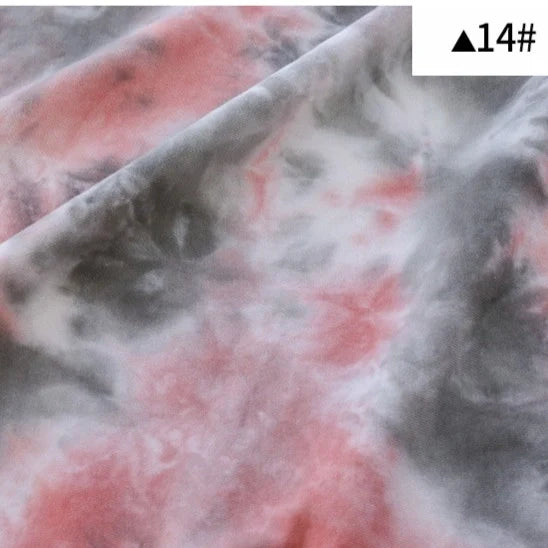 Gros plan du tissu Longan Craft France Tissu French Terry en coton tie-dye, montrant son motif dégradé rose, blanc et gris. Une petite étiquette portant la mention "14#" et un triangle noir se trouve dans le coin supérieur droit.