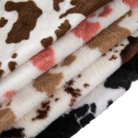 Tissu pelucheux imprimé taches de vache au mètre