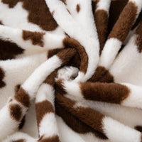 Tissu pelucheux imprimé taches de vache au mètre
