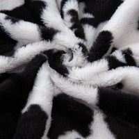 Tissu pelucheux imprimé taches de vache au mètre
