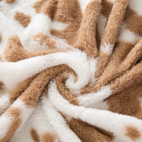 Tissu pelucheux imprimé taches de vache au mètre