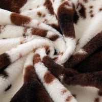 Tissu pelucheux imprimé taches de vache au mètre