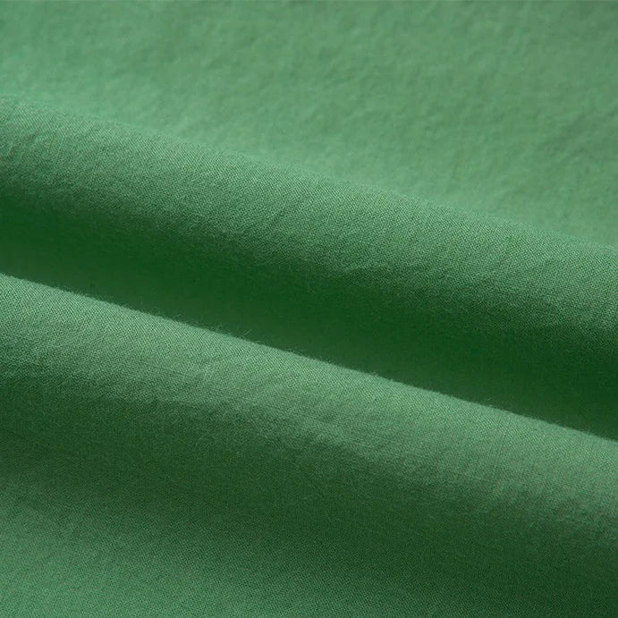 Gros plan sur le Tissu linon de coton tissé au mètre de Longan Craft France, montrant sa texture multicolore et ses plis de coton doux avec des ombres et des lumières sur la surface.