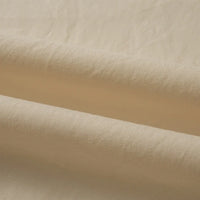 Un gros plan du Tissu linon de coton tissé au mètre par Longan Craft France montre sa texture lisse et douce avec des rides subtiles. Cette doublure coton haute douceur, multicolore, est parfaite pour des projets de couture polyvalents et est disponible au mètre.