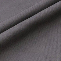 Un gros plan du Tissu jean coloré 7,5 oz au mètre de Longan Craft France montre son tissage sergé multicolore 100 % coton, avec des lignes diagonales et une texture lisse. Le denim de haute qualité est légèrement plié, ce qui crée des ombres douces.