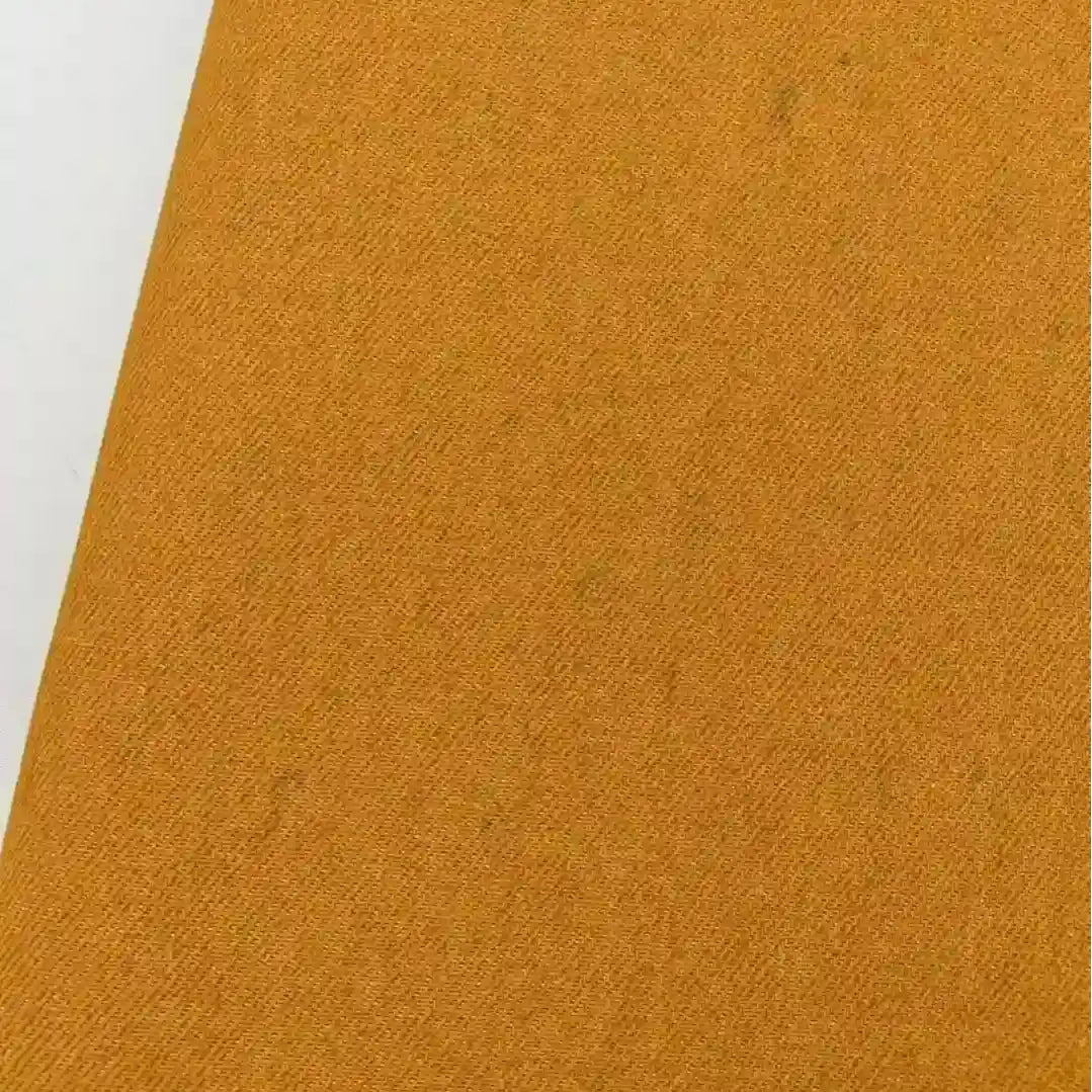Gros plan sur le tissu jean tissé coloré au mètre (denim sergé teint 6,5 oz en coton) de Longan Craft France, présenté en diagonale avec un bord blanc-idéal pour une décoration intérieure élégante.