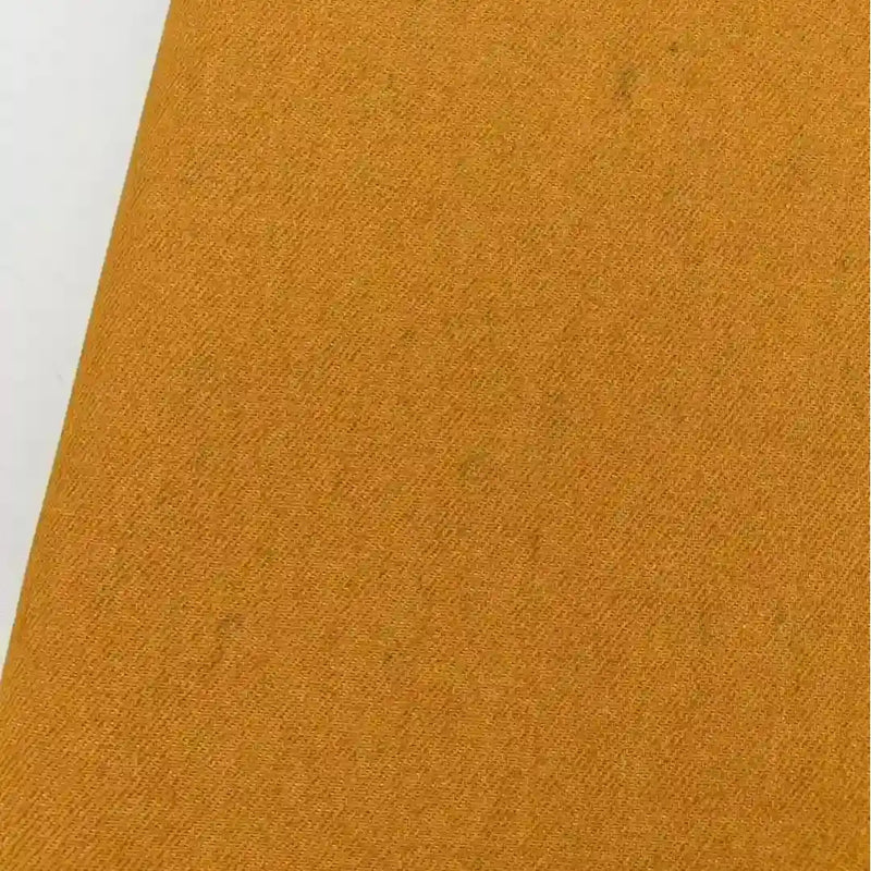 Gros plan sur le tissu jean tissé coloré au mètre (denim sergé teint 6,5 oz en coton) de Longan Craft France, présenté en diagonale avec un bord blanc-idéal pour une décoration intérieure élégante.
