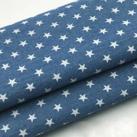 Deux pièces de tissu denim coton léger imprimé de fleurs et d'étoiles Longan Craft France, empilées-parfaites pour la confection de vêtements.