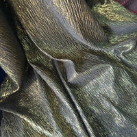 Gros plan sur le tissu lamé froissé au mètre de Longan Craft France : un tissu polyester texturé et métallisé de couleur noire avec des reflets dorés et verts, idéal pour les costumes de scène, les robes et les projets de couture.