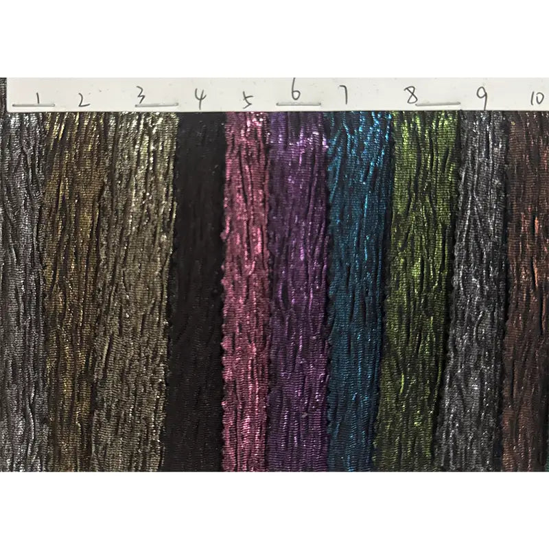Dix échantillons du tissu lamé froissé au mètre de Longan Craft France, un tissu de costume en polyester métallisé brillant, sont numérotés de 1 à 10 sur fond blanc et présentent des nuances de bronze, noir, rose, violet, bleu, vert, gris et marron.