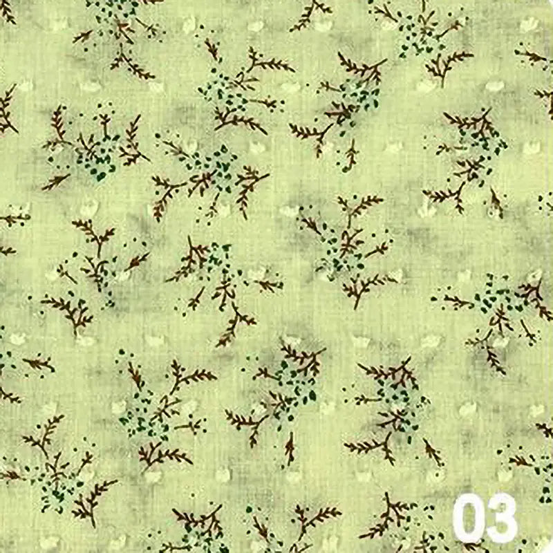 Tissu plumetis en voile jacquard vert clair de Longan Craft France, présentant un fond subtilement texturé avec de petites branches brunes et des feuilles vertes. Idéal pour robes d'été. Tissu voile jacquard au mètre, motif floral "03" en blanc en bas à droite.