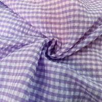 Un gros plan du Seersucker vichy au mètre de Longan Craft France montre sa texture froncée et légère de seersucker et ses petits carreaux régulièrement espacés, idéaux pour les projets légers.