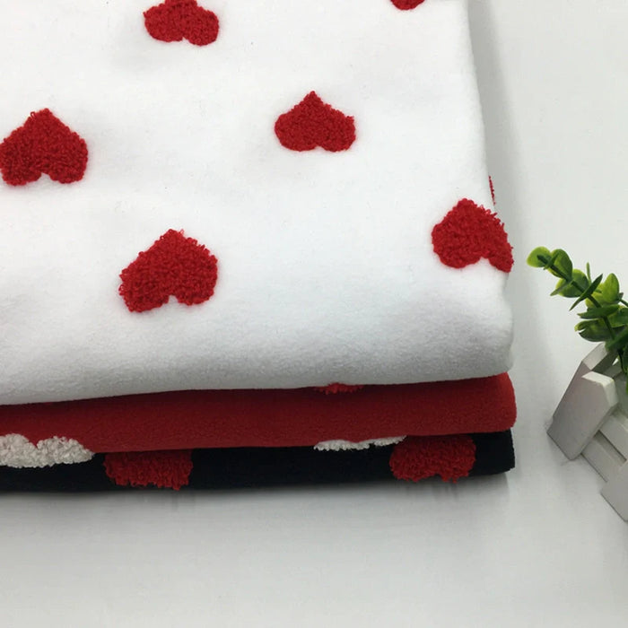 Tissu polaire à motifs cœurs au mètre
