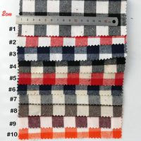Dix échantillons de "Tissu flanelle à carreaux au mètre" de Longon Craft France sont disposés verticalement et étiquetés #1-#10, avec une règle de centimètre au-dessus pour montrer l'échelle et mettre en évidence les options de tissu polyester-coton coloré.
