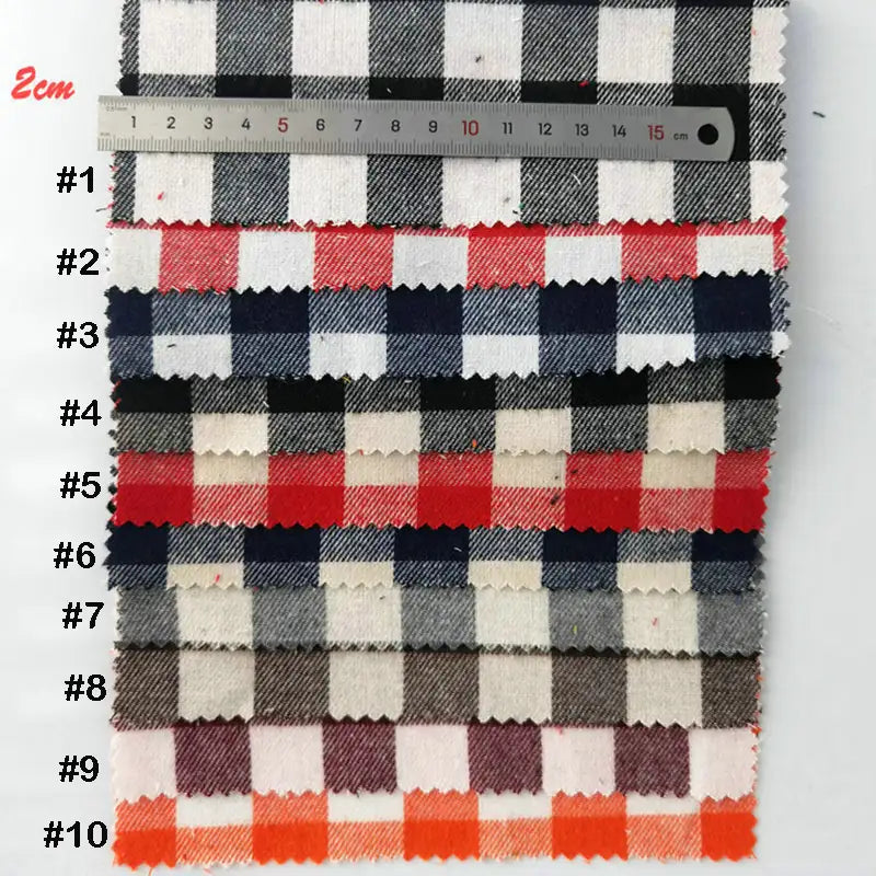 Dix échantillons de "Tissu flanelle à carreaux au mètre" de Longon Craft France sont disposés verticalement et étiquetés #1-#10, avec une règle de centimètre au-dessus pour montrer l'échelle et mettre en évidence les options de tissu polyester-coton coloré.