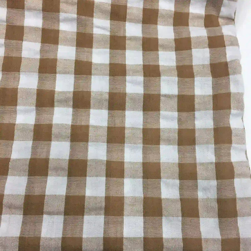 Découvrez le Tissu seersucker à motif vichy de Longan Craft France : un tissu léger à carreaux marron clair et blanc, légèrement gaufré, idéal pour des vêtements d'été. Disponible au mètre.