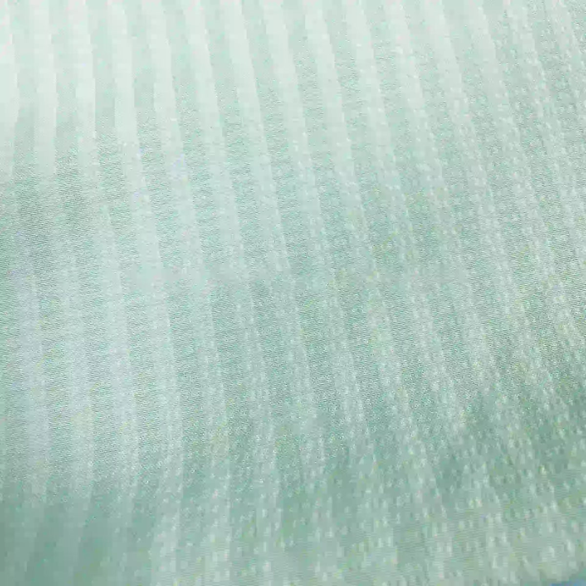 Gros plan sur le Seersucker à larges rayures au mètre de Longan Craft France, un seersucker bleu clair en polyester avec des rayures verticales - idéal comme tissu léger décoration intérieure ou chemise vintage.