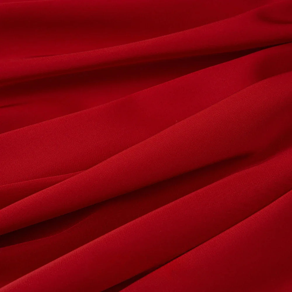 Gros plan sur le Tissu mousseline satinée au mètre de Longan Craft France, un tissu extensible, doux et soyeux d'un rouge éclatant, parfait pour les tenues de soirée élégantes et les créations vestimentaires.