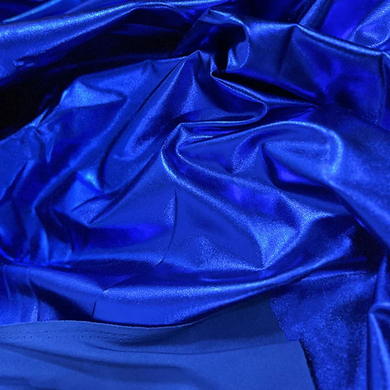 Gros plan sur un tissu lamé stretch au mètre bleu royal brillant et froissé de Longan Craft France, un tissu brillant en polyester idéal pour la couture, le bricolage et l'ameublement, montrant des plis réfléchissant la lumière et une texture luxueuse.