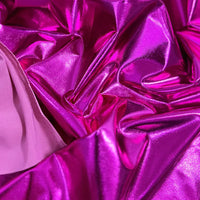 Gros plan sur le Tissu lamé stretch au mètre de Longan Craft France en rose métallisé, associé à un tissu lisse rose clair. La surface brillante en polyester reflète la lumière, ce qui est parfait pour la couture, les loisirs créatifs ou la tapisserie.