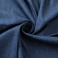 Un gros plan du Tissu en jean coton lavé 14,5 oz au mètre de Longan Craft France montre son denim bleu foncé épais, froncé pour mettre en valeur le tissage de qualité supérieure et le léger lustre - idéal pour les jeans de qualité ou l'artisanat.